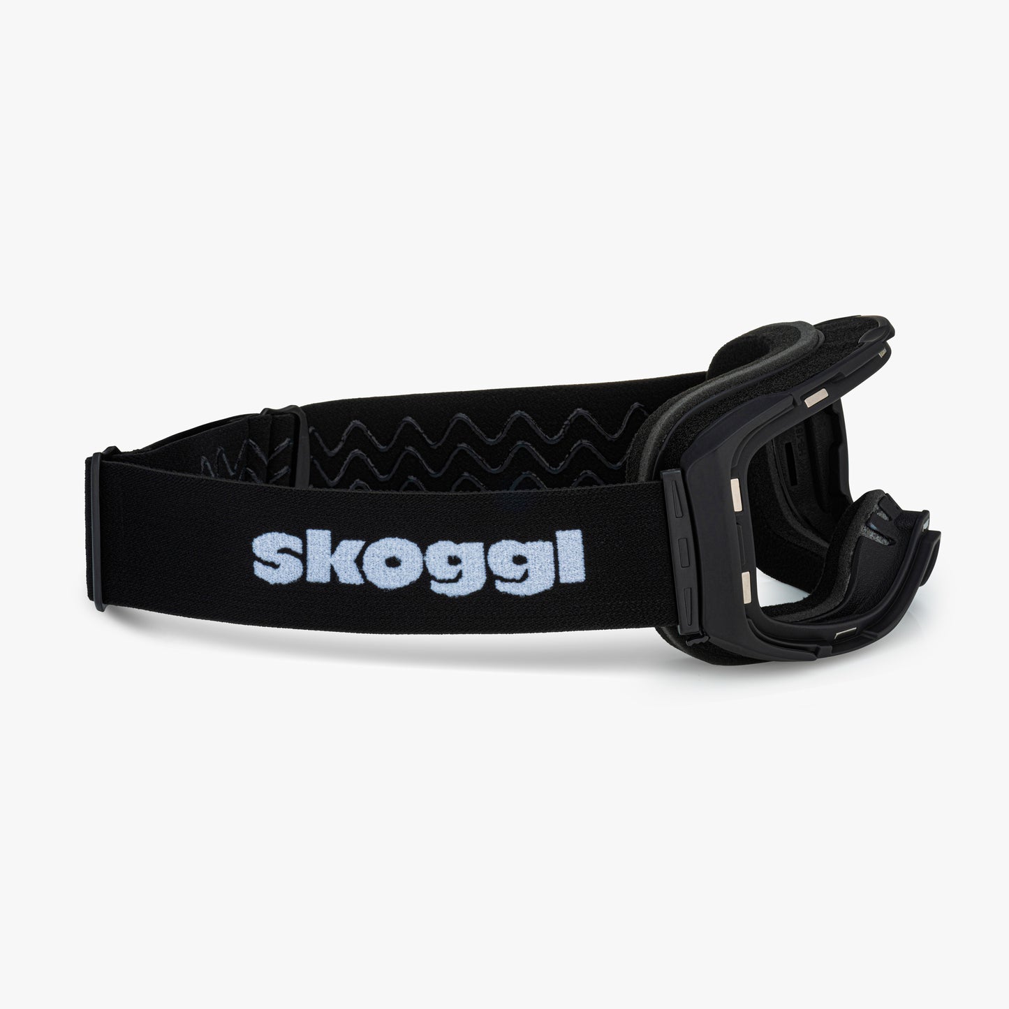Black ski and snowboard goggle frames with black interior padding and an adjustable black strap featuring the brand name 'Skoggl' in black letters. Shown without lenses to highlight the magnetic lens slot, set against a plain white background. Perfect for customizable, high-performance ski and snowboard gear.