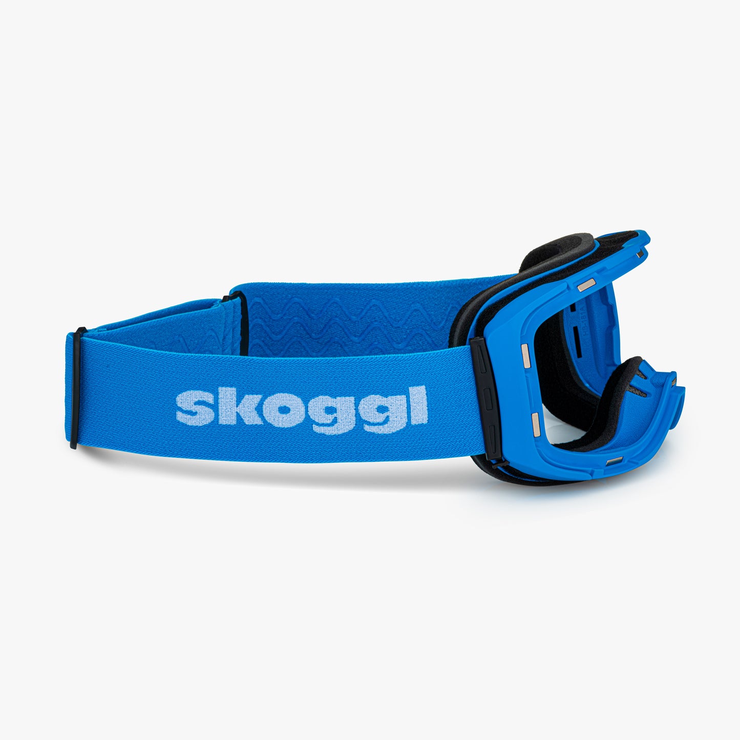 Blue ski and snowboard goggle frames with black interior padding and an adjustable Blue strap featuring the brand name 'Skoggl' in black letters. Shown without lenses to highlight the magnetic lens slot, set against a plain white background. Perfect for customizable, high-performance ski and snowboard gear.