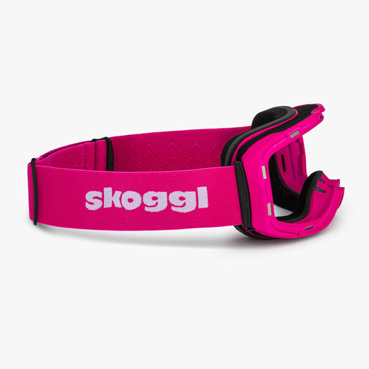 Pink ski and snowboard goggle frames with black interior padding and an adjustable Pink strap featuring the brand name 'Skoggl' in black letters. Shown without lenses to highlight the magnetic lens slot, set against a plain white background. Perfect for customizable, high-performance ski and snowboard gear.