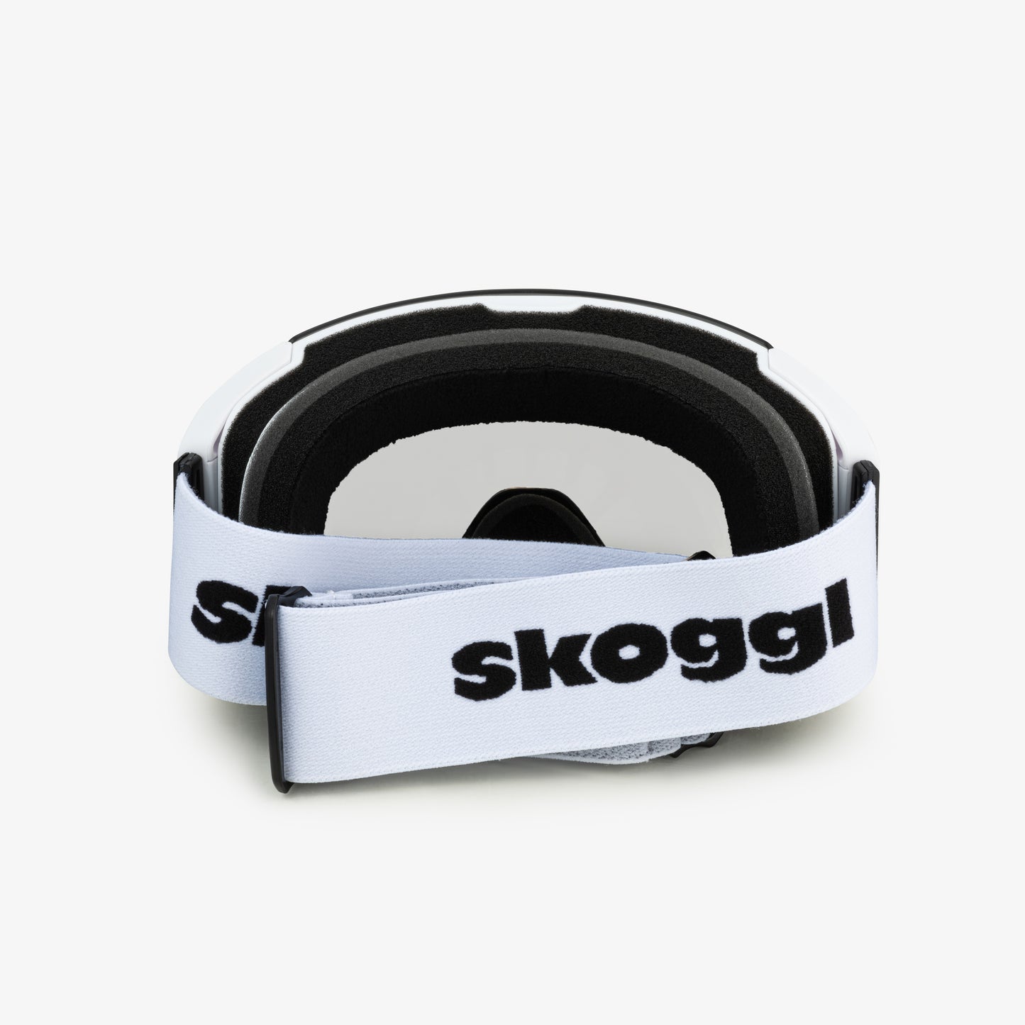 White ski and snowboard goggles with a wide white strap featuring the word 'Skoggl', shown from the back. Clear lenses are visible through the frame, paired with black cushioning for comfort and a secure fit. Perfect for customizable, stylish ski and snowboard gear designed for performance on the slopes.
