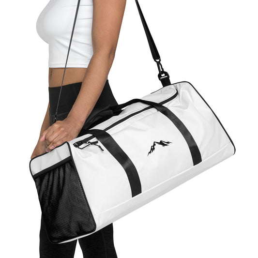 White duffel bag with black skoggl logo held by a woman on a white background