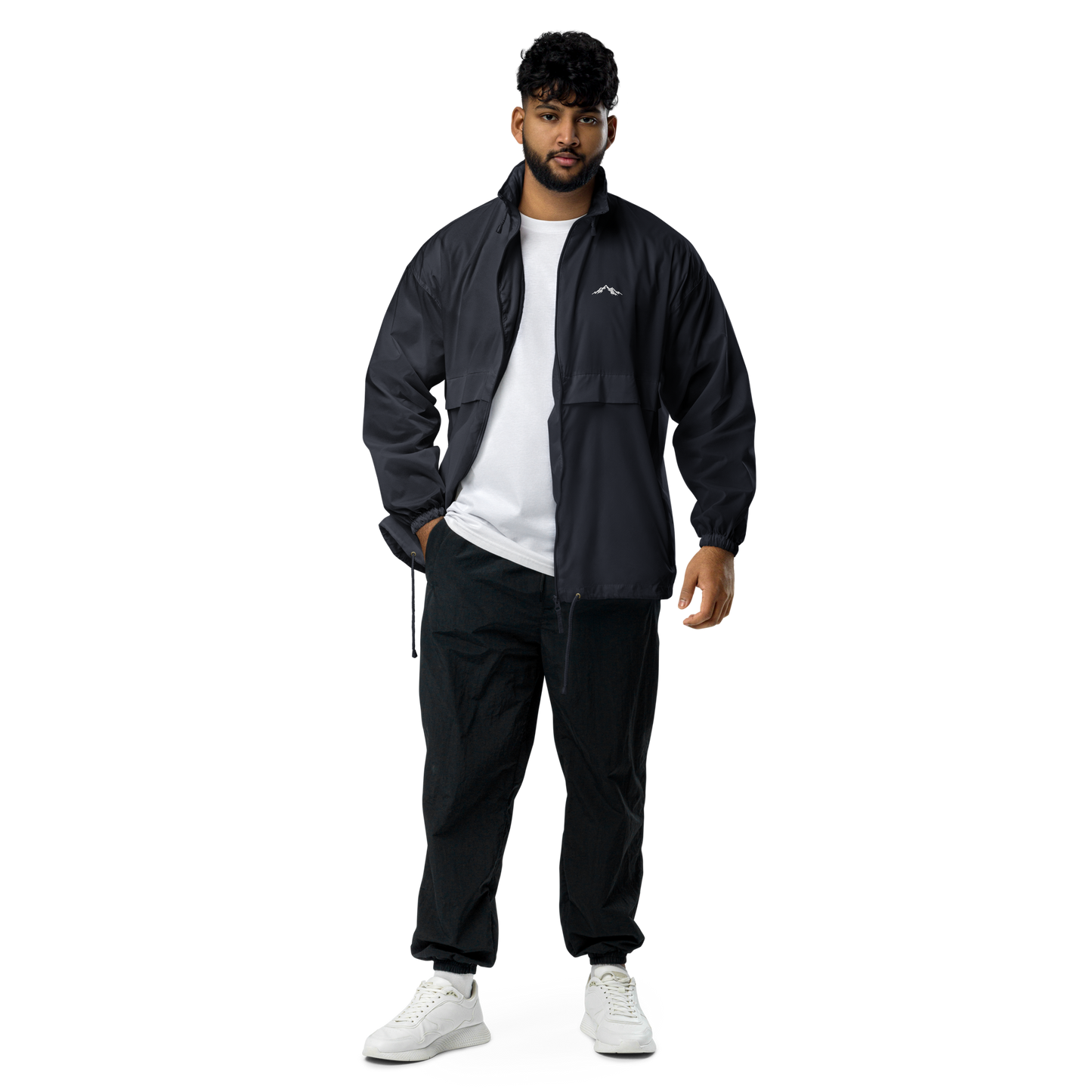 Model wearing navy windproof jacket with a small skoggl logo on the right chest