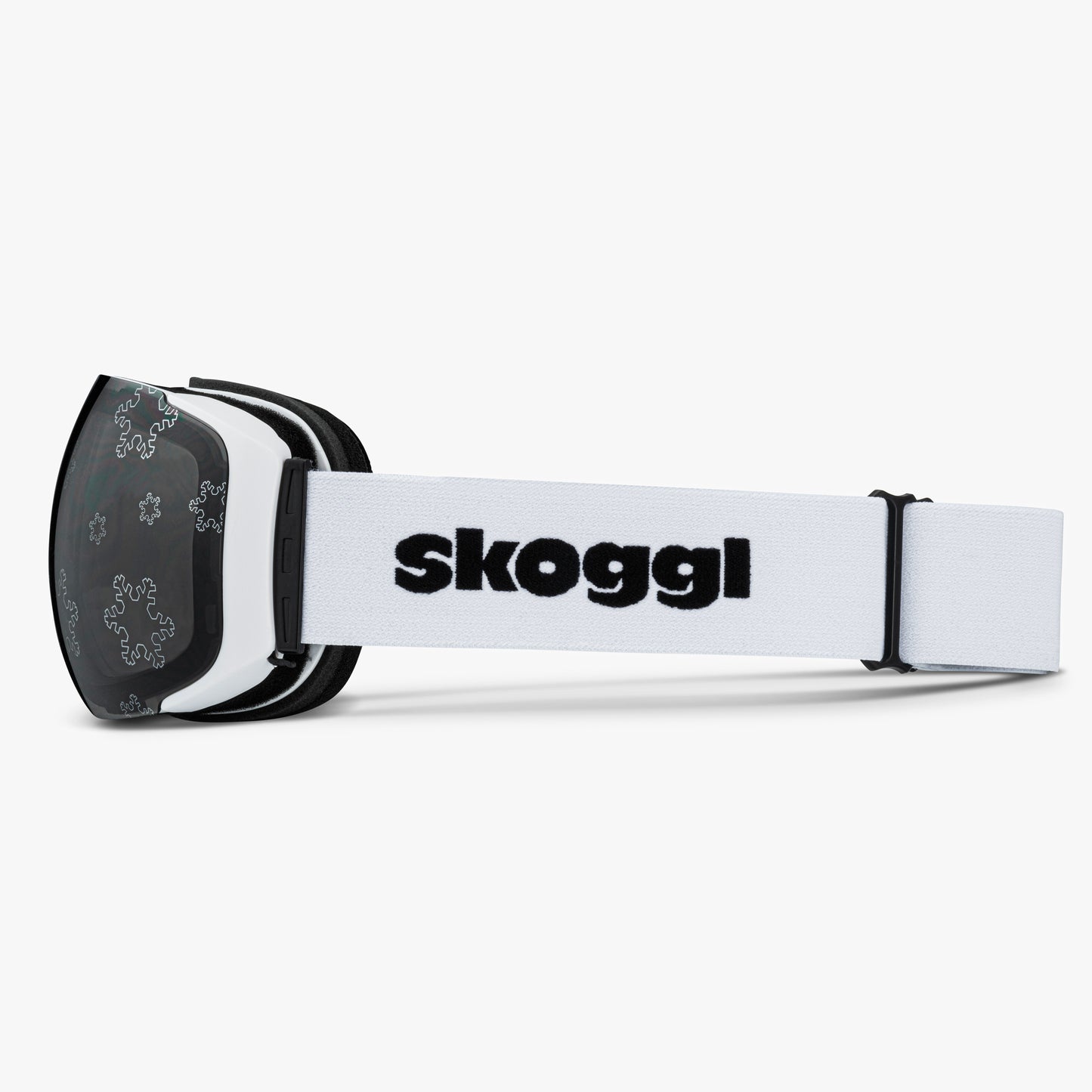 White ski and snowboard goggles with silver snowflake outlines on the lenses, showcasing the delicate snowflake Lens designs. Features the word 'Skoggl' on the strap, highlighting customizable, magnetic goggles for style and performance on the slopes.