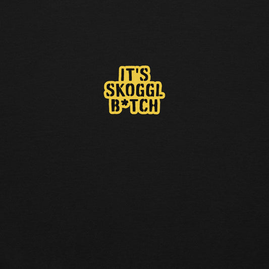 Close-up of the yellow ‘It’s Skoggl B*tch’ patch on a black hoodie.