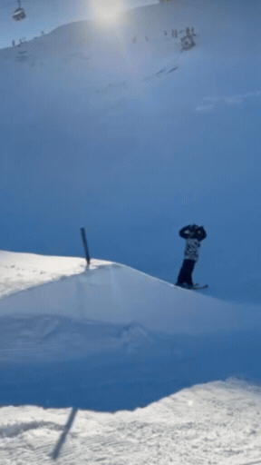 GB Freestyle Ski Champion Hatti Wilson performing a jump on a snowy mountain wearing Skoggl children's high-performance ski goggles.