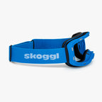 Blue ski and snowboard goggle frames with black interior padding and an adjustable Blue strap featuring the brand name 'Skoggl' in black letters. Shown without lenses to highlight the magnetic lens slot, set against a plain white background. Perfect for customizable, high-performance ski and snowboard gear.