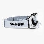 White ski and snowboard goggle frames with black interior padding and an adjustable White strap featuring the brand name 'Skoggl' in black letters. Shown without lenses to highlight the magnetic lens slot, set against a plain white background. Perfect for customizable, high-performance ski and snowboard gear.