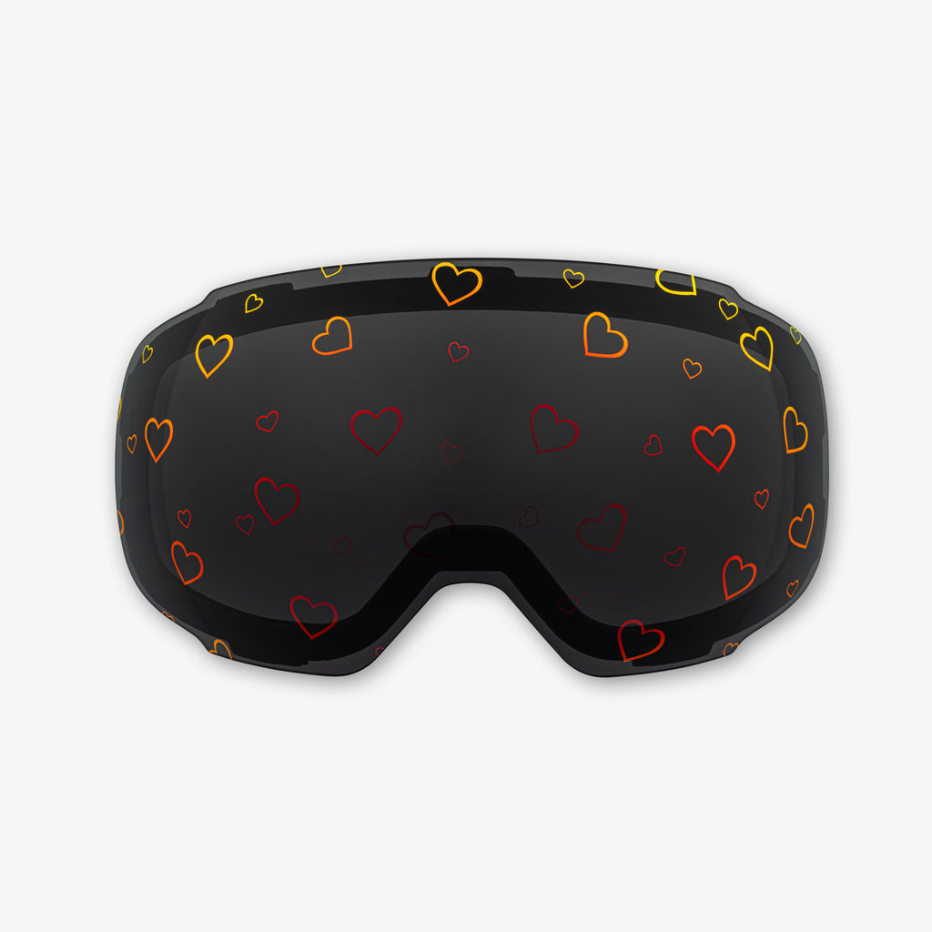 Close-up of the Sweetheart Lens, a magnetic ski and snowboard goggle lens featuring playful heart designs. Showcases the easy-swap magnetic feature, vibrant colors, and high-quality clarity for style and performance on the slopes. Perfect for pairing with Skoggl frames.