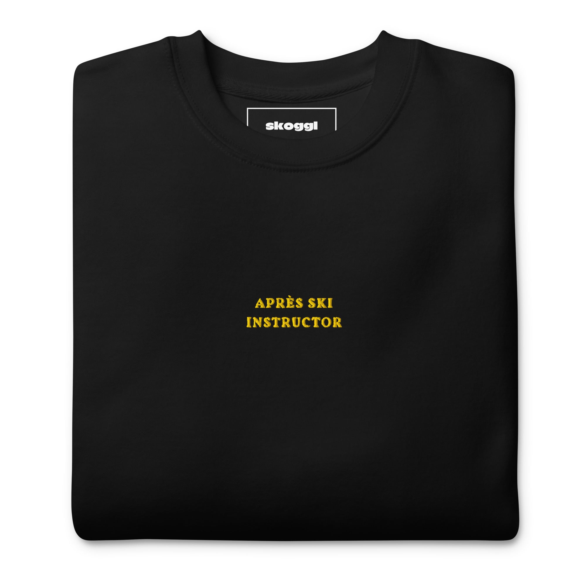Black Skoggl Après Ski Instructor sweatshirt with yellow embroidered chest text, fleece-lined for warmth.