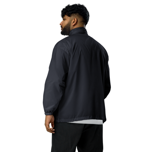 Model wearing navy windproof jacket with a small skoggl logo on the right chest 