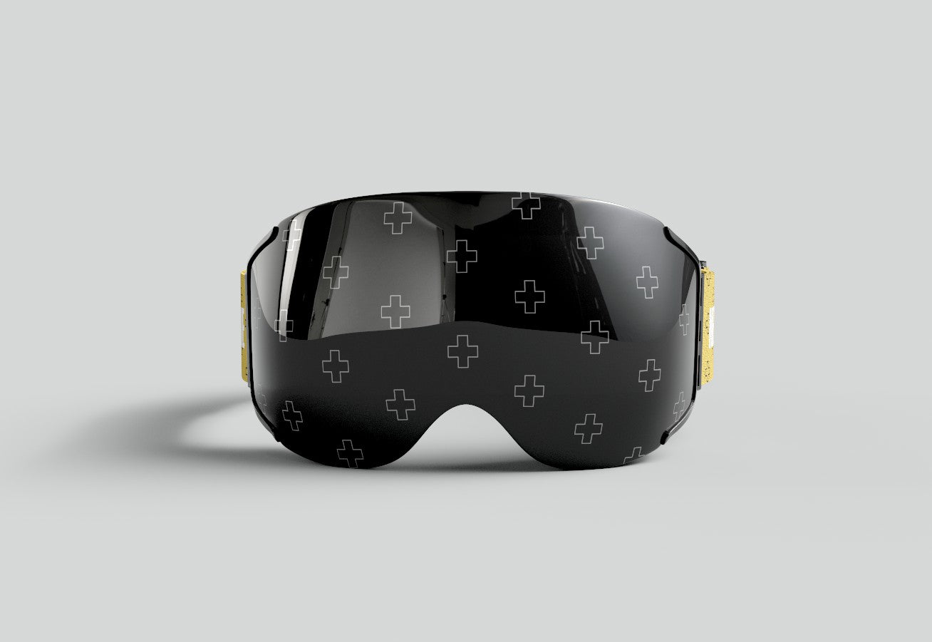 Front view of Skoggl custom ski and snowboard goggles for John Crist’s Net Positive team, featuring a black magnetic lens with a repeating white 'plus' sign pattern that is invisible to the wearer.