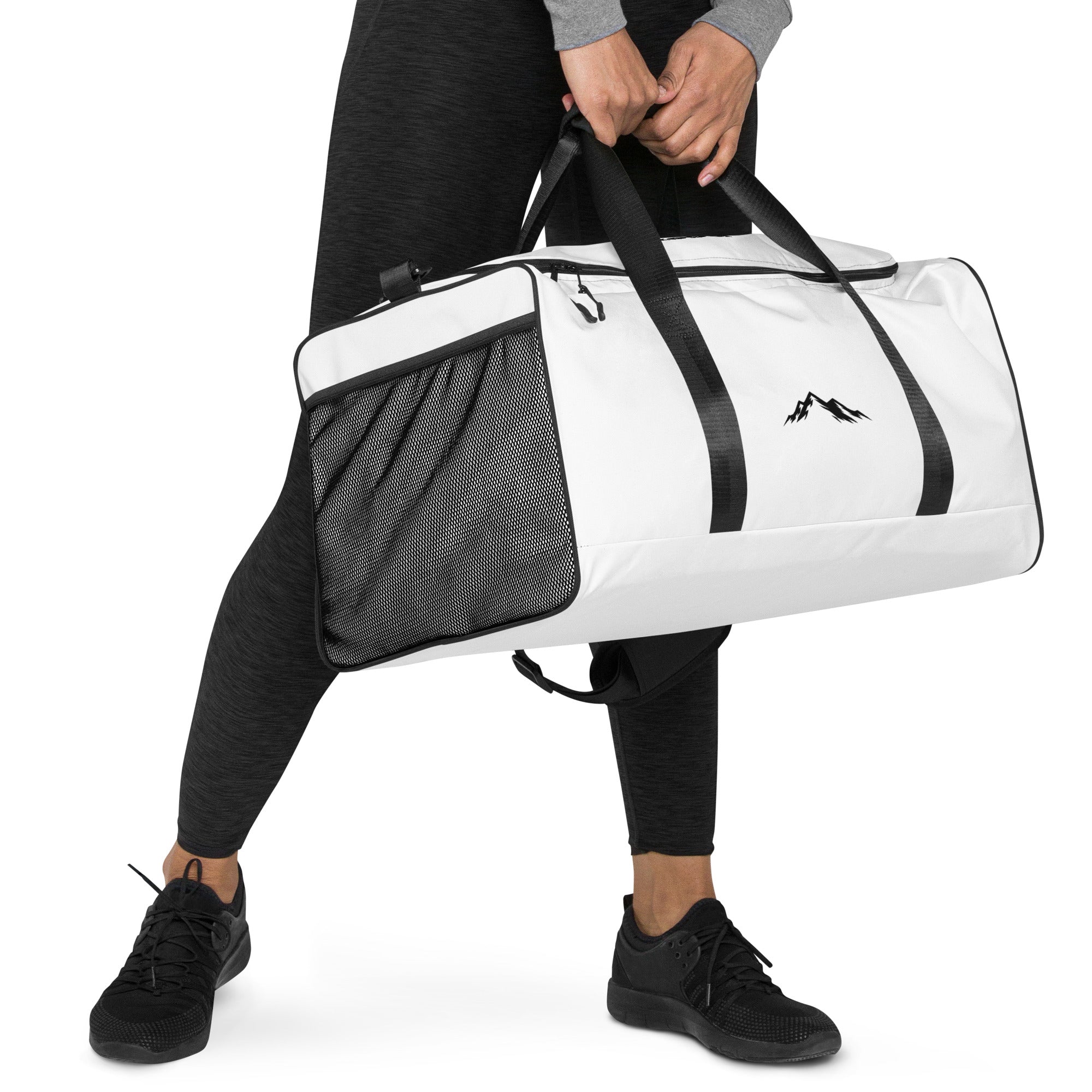 Woman holding a white and black duffel bag with a skoggl on a white background