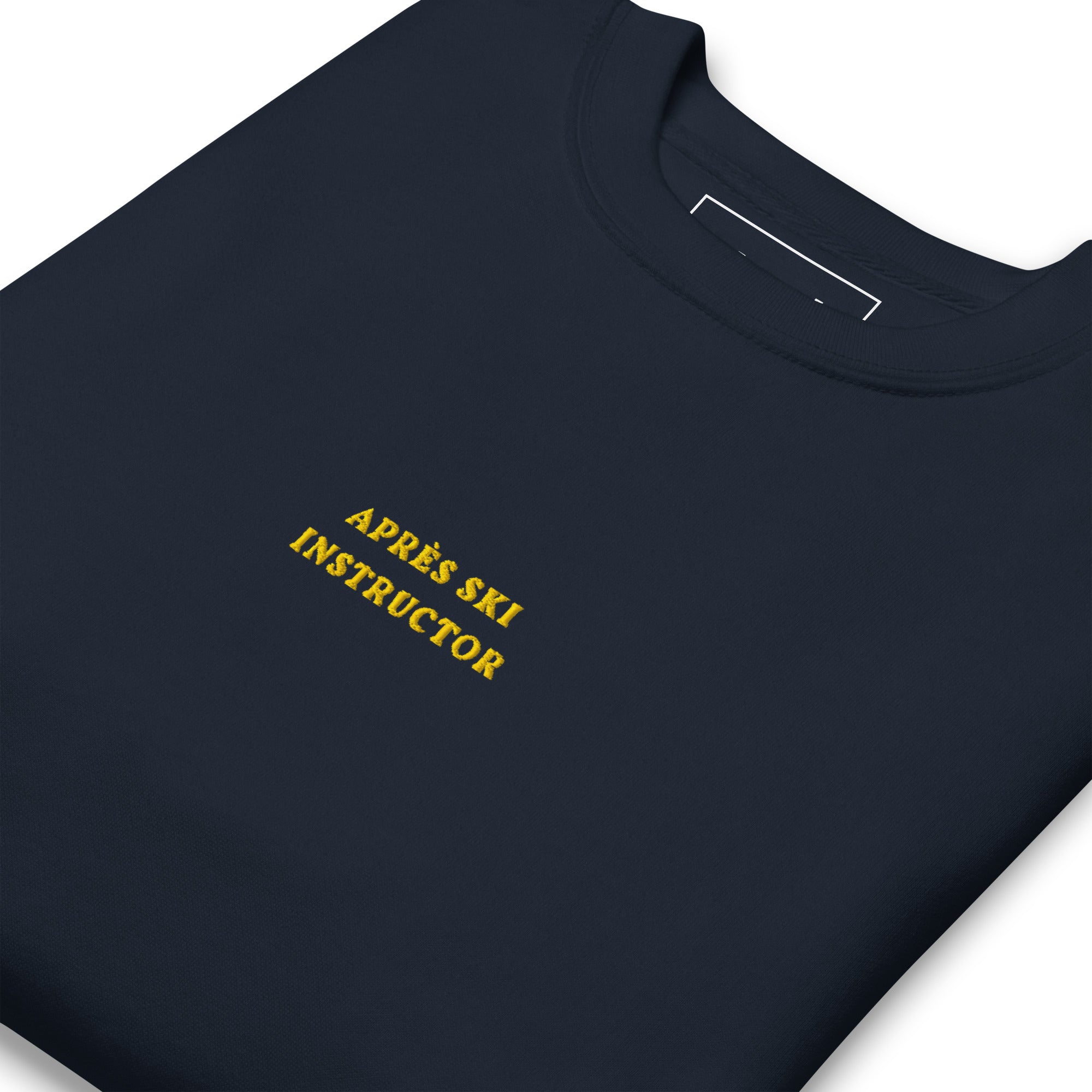 Navy Skoggl Après Ski Instructor sweatshirt with yellow embroidered chest text, fleece-lined for warmth.