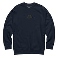 Navy Skoggl Après Ski Instructor sweatshirt with yellow embroidered chest text, fleece-lined for warmth.