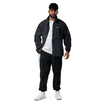 Model wearing navy windproof jacket with a small skoggl logo on the right chest 