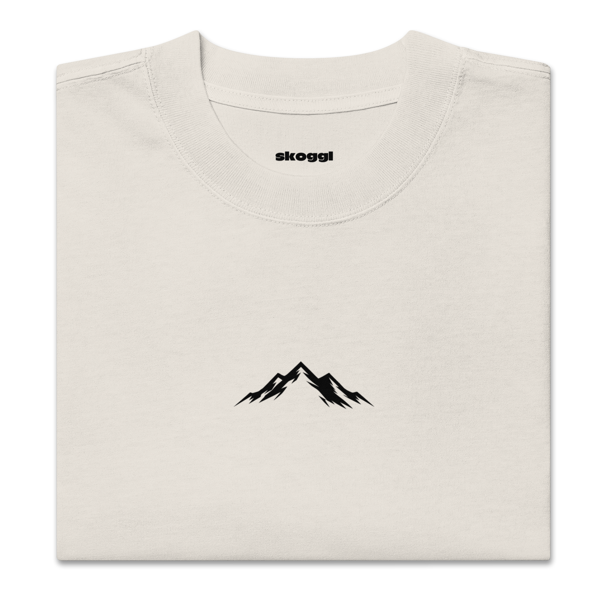 Beige t-shirt with black mountain design and 'skoggl' branding on a white background
