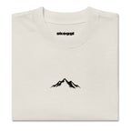 Close-up detail of the black Skoggl mountain logo printed on heavyweight 100% premium carded cotton in Washed Oat.