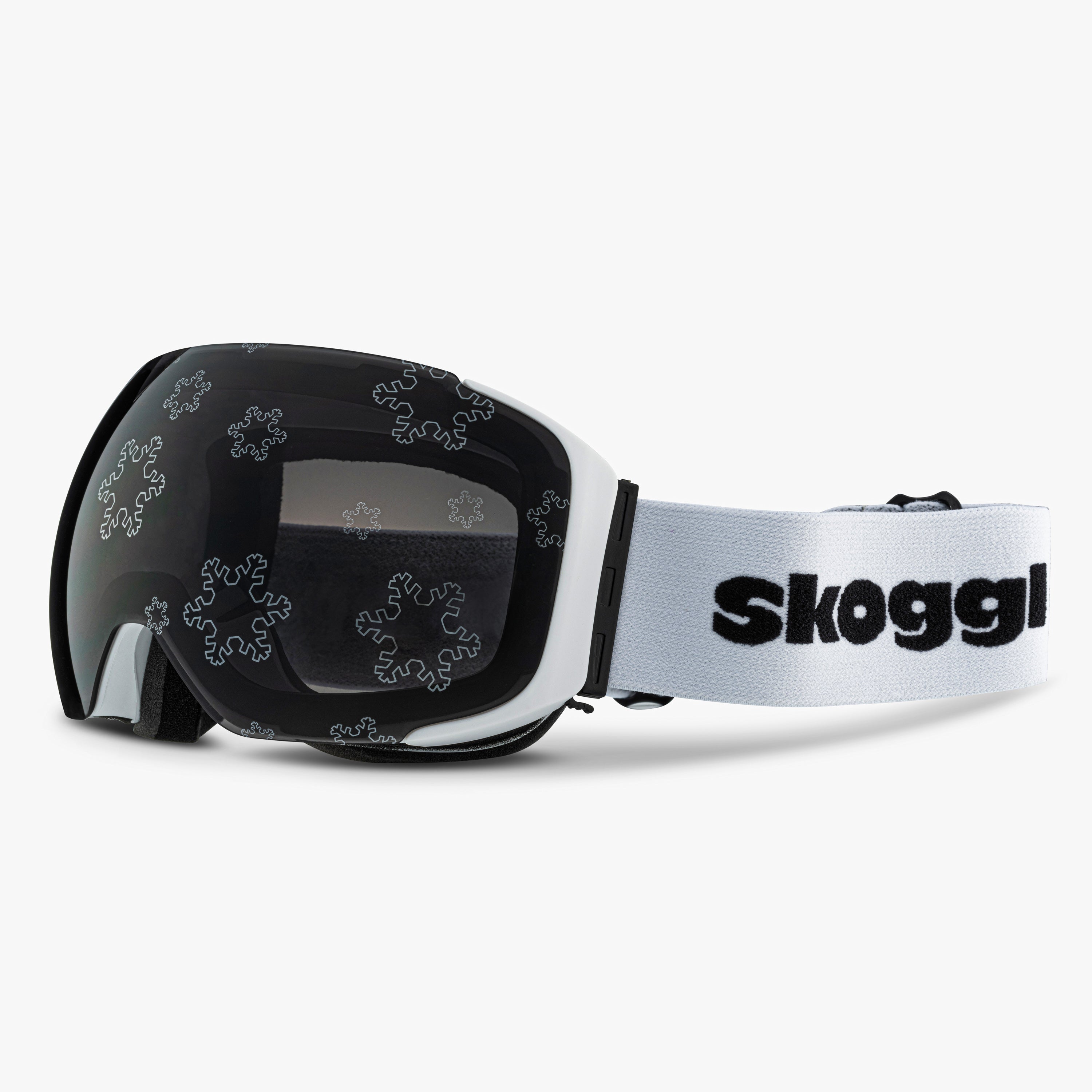 White ski and snowboard goggles with silver snowflake designs on the lenses, showcasing the delicate snowflake Lens. Features the word 'Skoggl' on the strap, highlighting customizable, magnetic goggles for style and performance on the slopes.