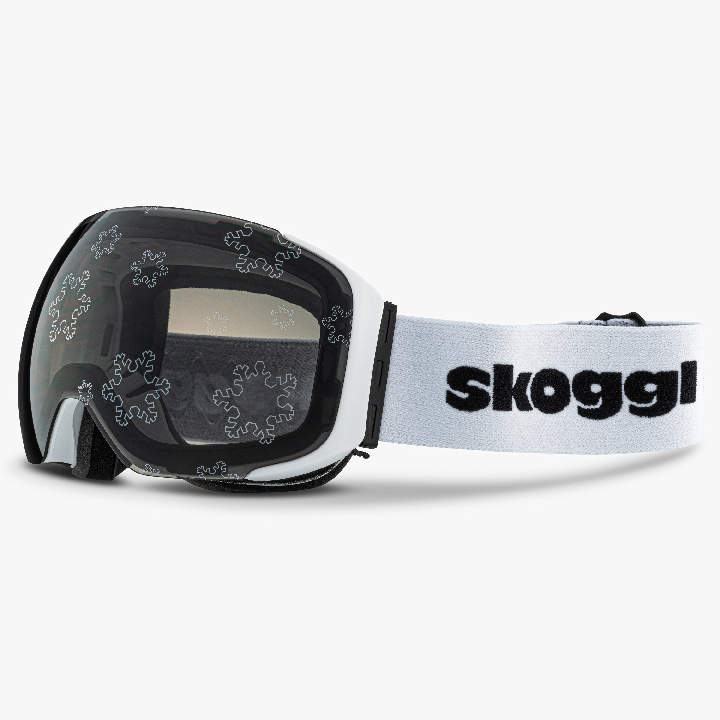 White ski and snowboard goggles with silver snowflake designs on the lenses, showcasing the delicate snowflake Lens. Features the word 'Skoggl' on the strap, highlighting customizable, magnetic goggles for style and performance on the slopes.