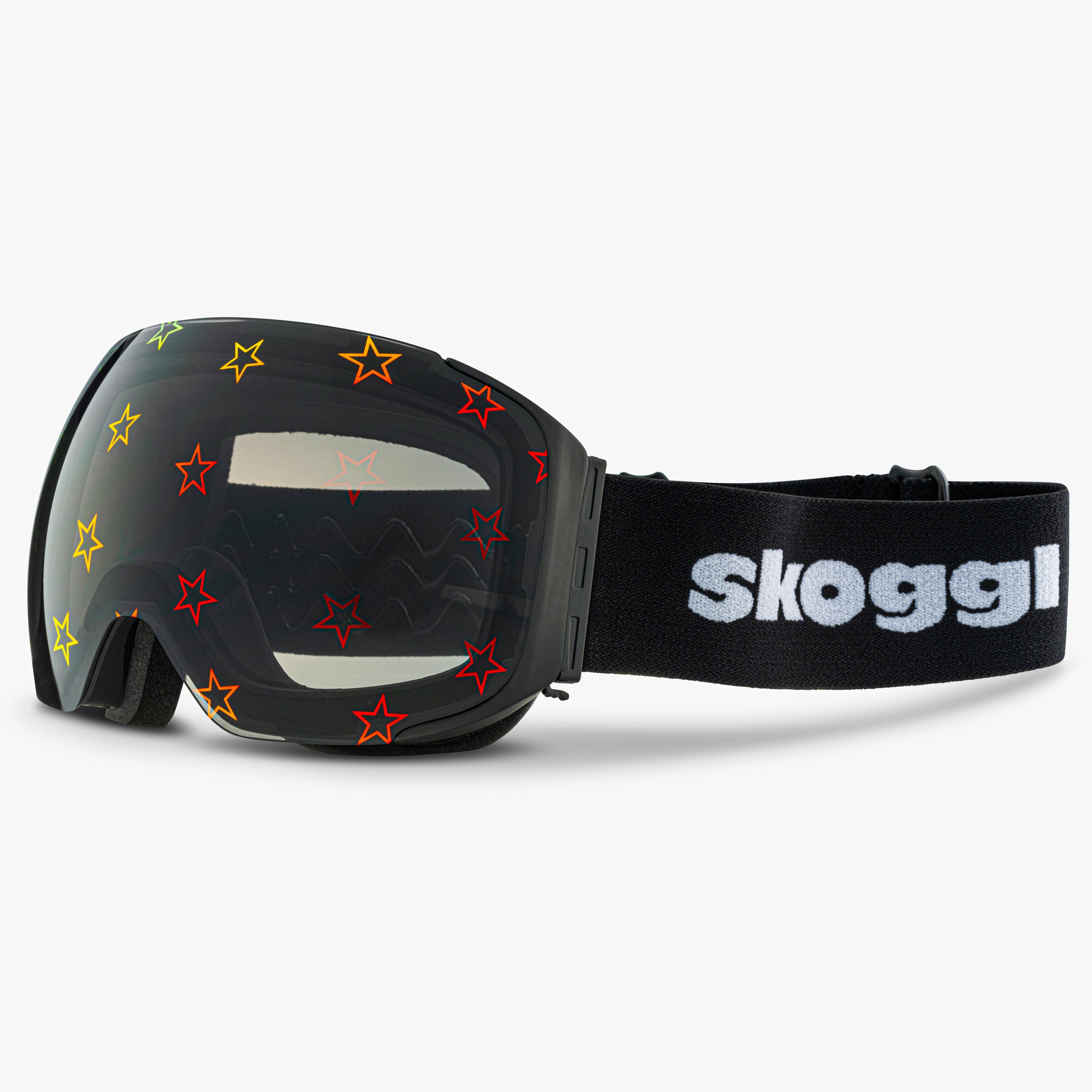 Black ski and snowboard goggles with star designs on the lenses, showcasing the bold Starstruck Lens. Features the word 'Skoggl' on the strap, highlighting customizable, magnetic goggles for style and performance on the slopes.