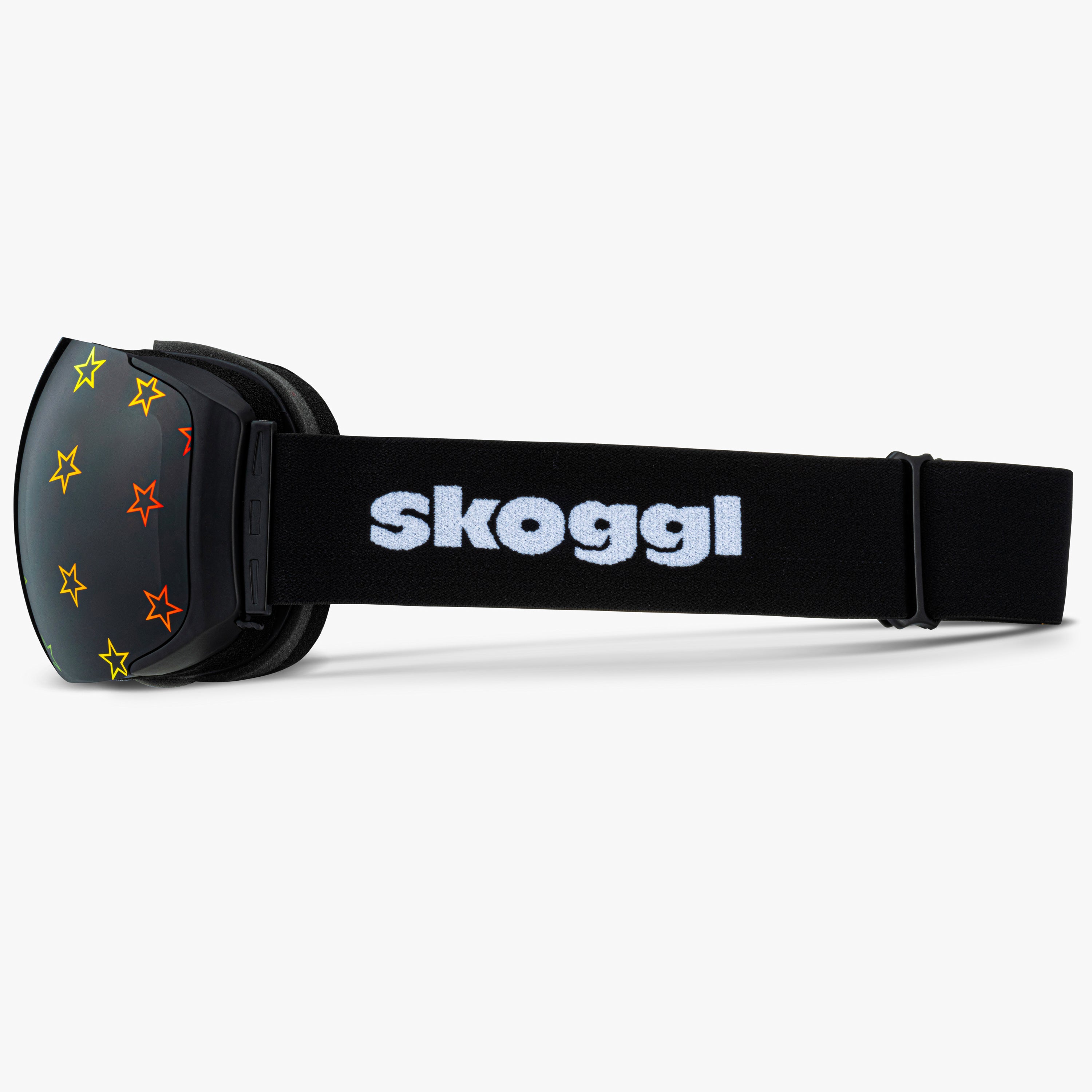 Black ski and snowboard goggles with bright star outlines on the lenses, showcasing the bold Starstruck Lens designs. Features the word 'Skoggl' on the strap, highlighting customizable, magnetic goggles for style and performance on the slopes.