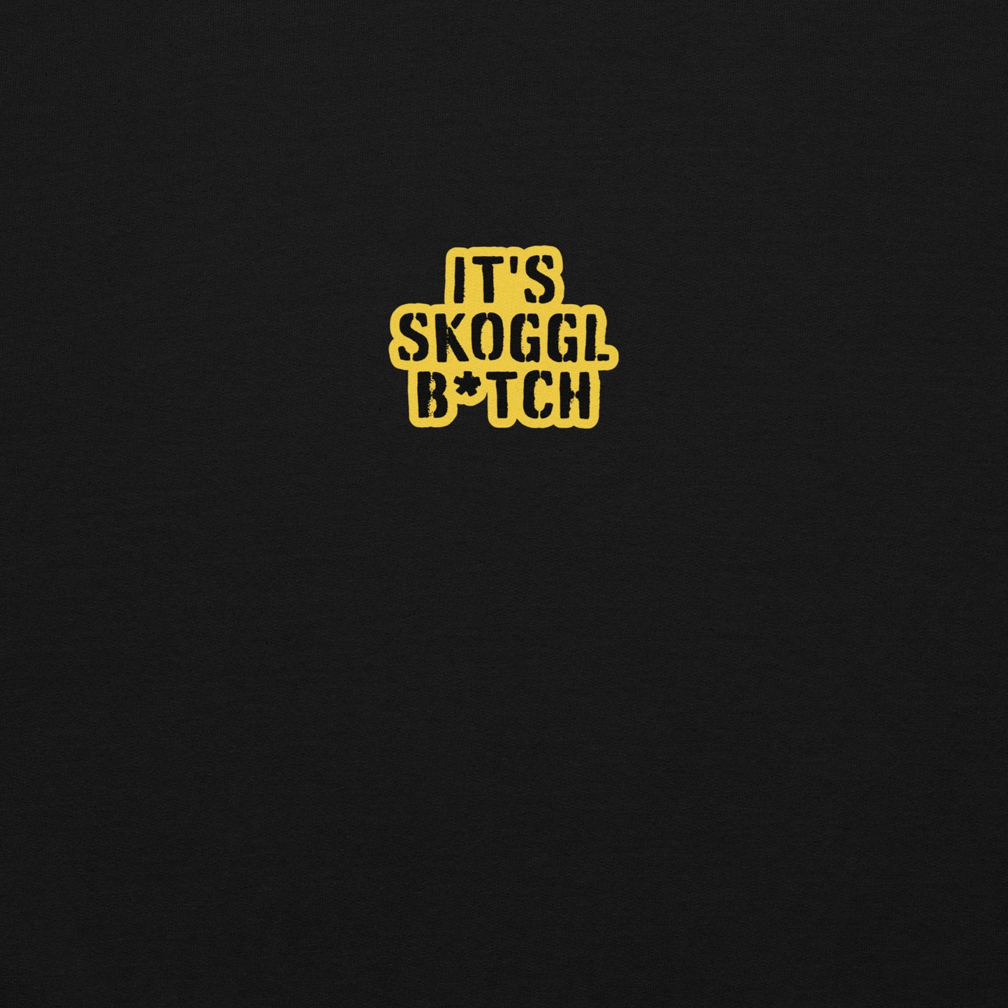 Close-up of the yellow ‘It’s Skoggl B*tch’ patch on a black hoodie.