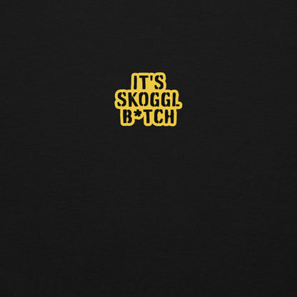 Close-up of the yellow ‘It’s Skoggl B*tch’ patch on a black hoodie.