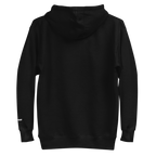 A plain black hooded sweatshirt shown from the back, with a small white text detail on the lower right sleeve near the cuff. The detail reads "skoggl".