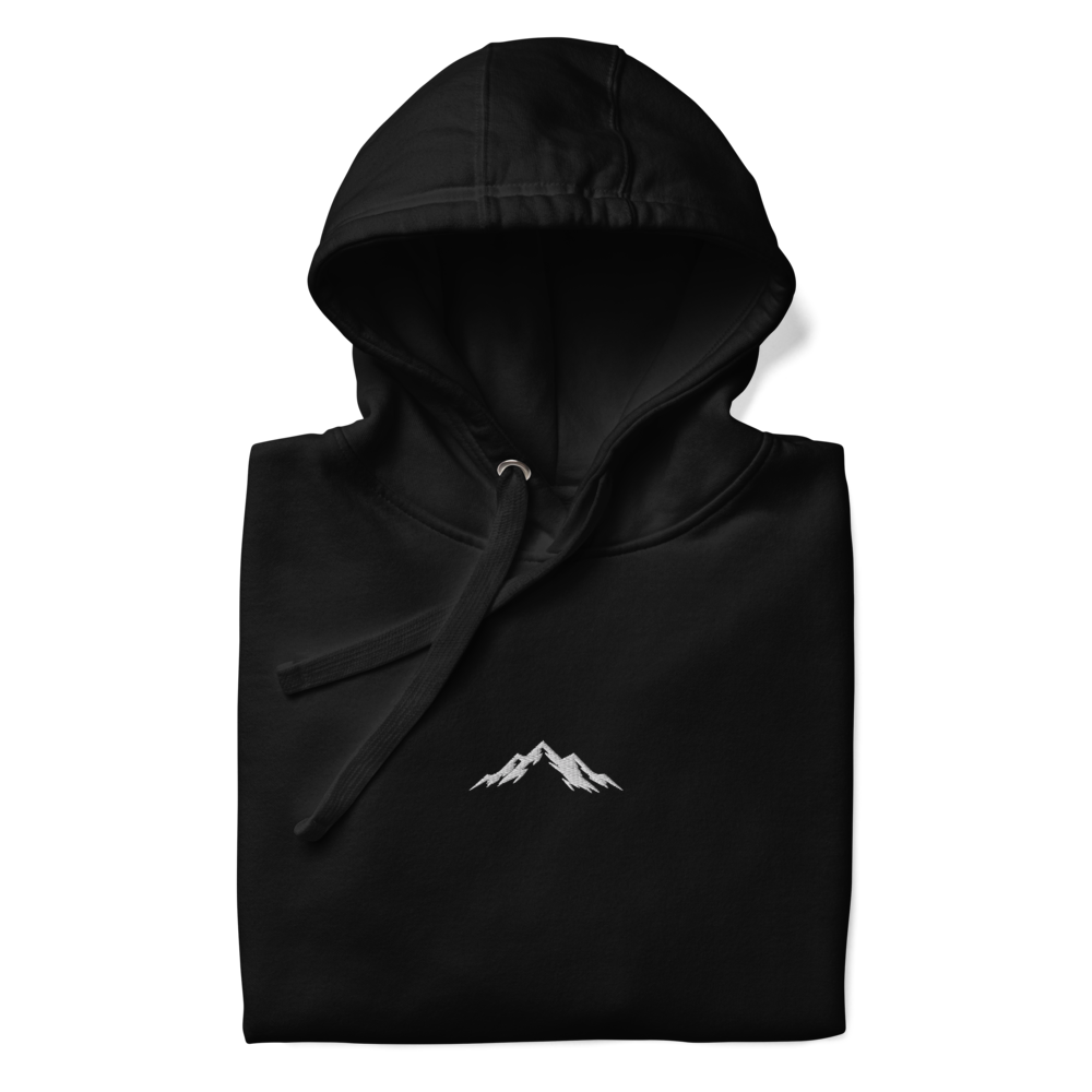 Black hoodie with a white skoggl mountain logo on a white background
