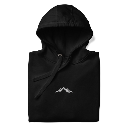 Black hoodie with a white skoggl mountain logo on a white background